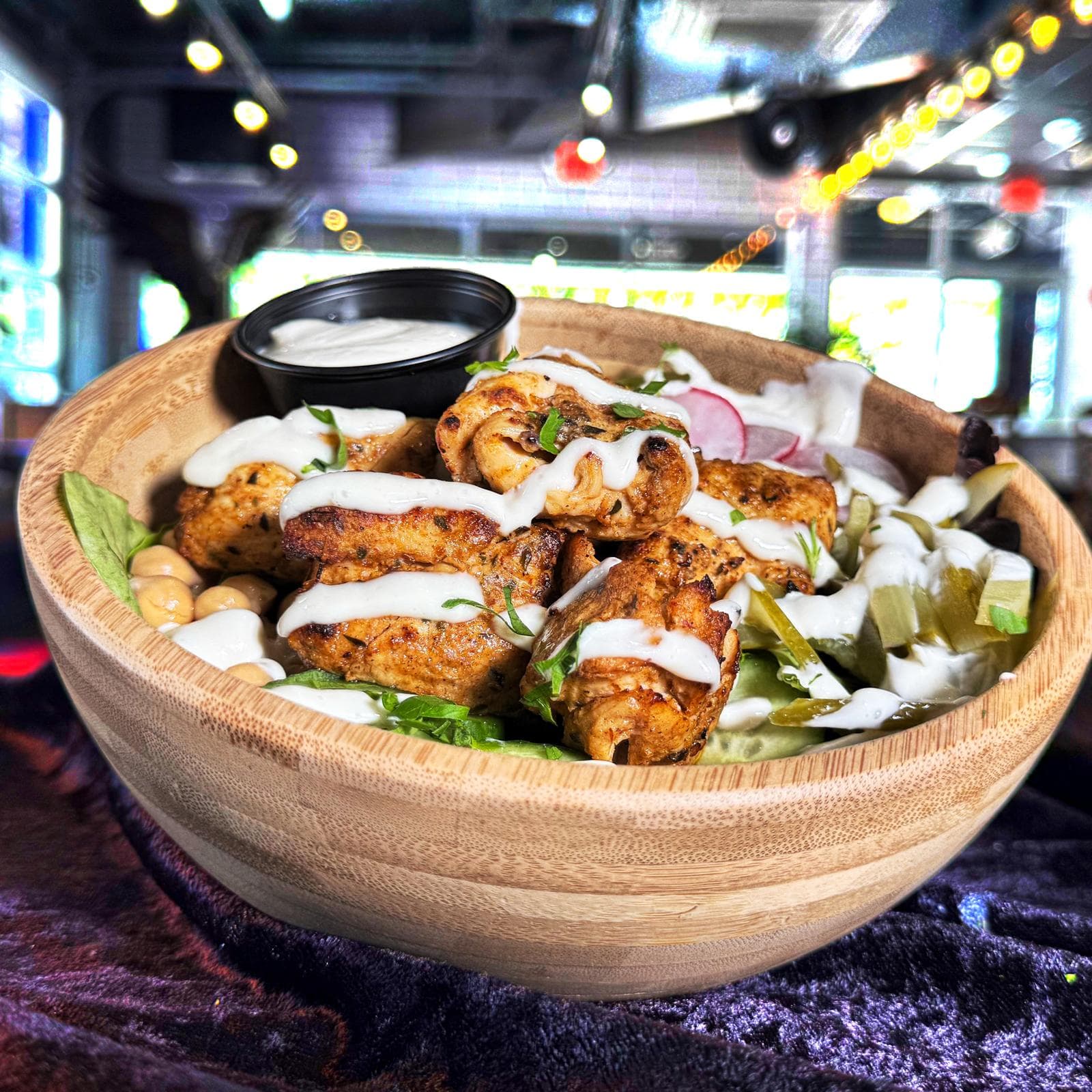 Mediterra Bowl with grilled chicken, chickpeas, pickles, and house sauce at Mediterra Houston
